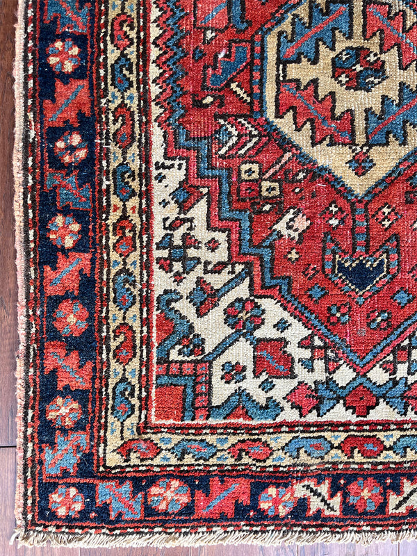 an antique heriz rug with a coral field and pretty blue accents