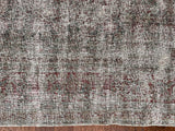 a large antique tabriz rug with a pared back crimson field and faded blue and green accents
