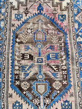 an antique hamadan rug with a soft pink field, a powder blue border and brown and cream accents