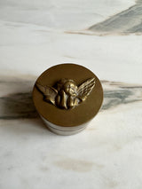 a pretty little brass trinket box with an carved cherub lid