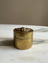 a pretty little brass trinket box with an carved cherub lid