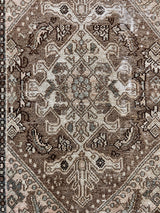 a mini malayer rug with a taupe field and cream accents