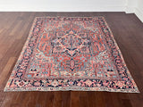 a large antique heriz rug with a coral field and bright icy blue, pink and coral accents