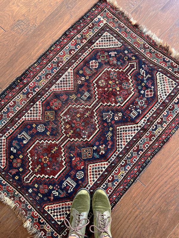 a mini shiraz rug with a classic navy blue and red palette