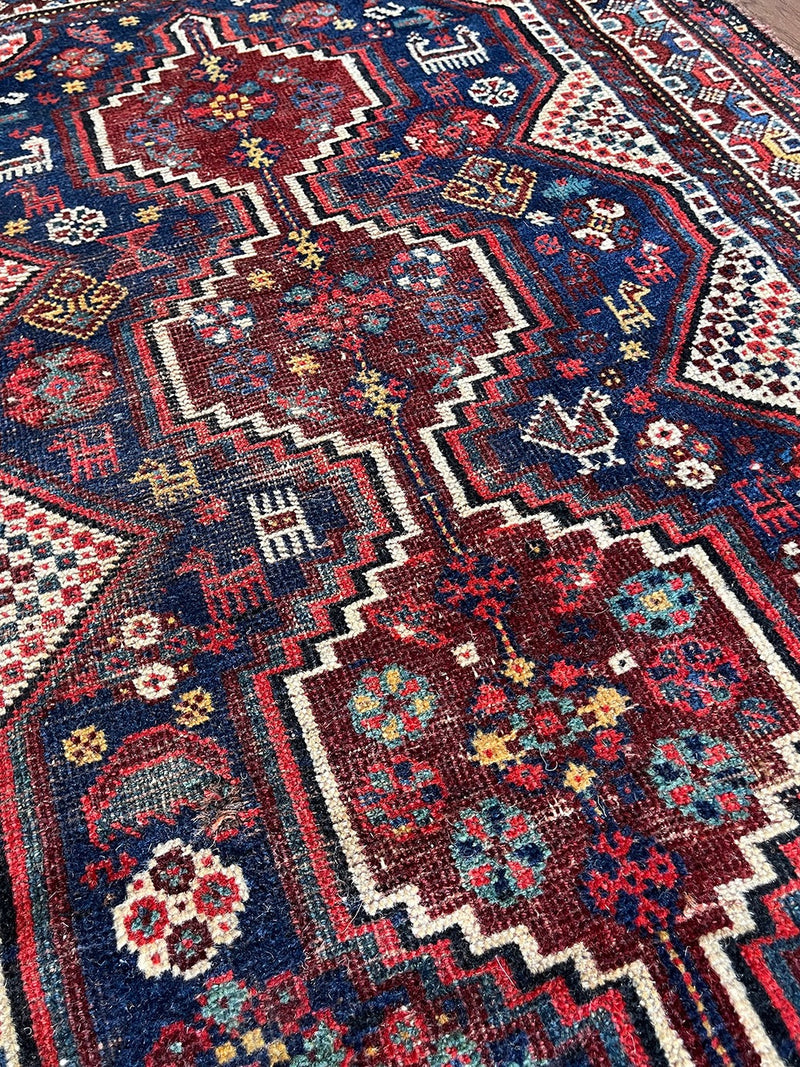  a mini shiraz rug with a classic navy blue and red palette