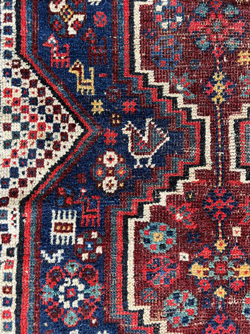 a mini shiraz rug with a classic navy blue and red palette
