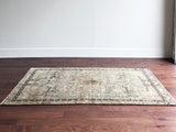 a vintage malayer rug with a teal field and detailed deer motifs 