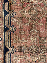 a mini hamadan rug, almost perfectly square in proportion with a coral field, a taupe floral pattern and a near black border
