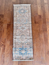 a vintage heriz runner with blue and taupe hues