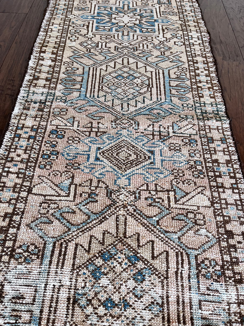 a vintage heriz runner with blue and taupe hues