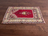 an antique turkish transylvanian rug with a pink/red field and a chandelier medallion