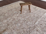 a large vintage kashan rug with a lilac taupe toned field and a pretty floral pattern