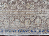 a large vintage kashan rug with a lilac taupe toned field and a pretty floral pattern