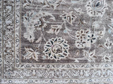 a large vintage kashan rug with a lilac taupe toned field and a pretty floral pattern