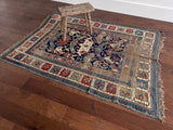 an antique caucasian shirwan rug with a royal blue field and brick red accents