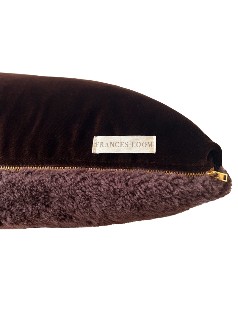 a square shearling pillow in chocolate brown shearling and plush velvet, with an exposed brass zipper