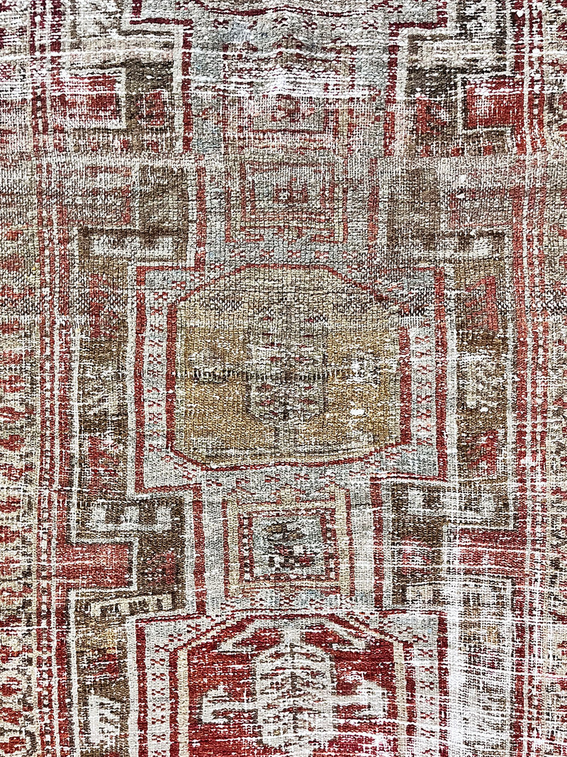 a beautiful antique heriz karajah runner with a brown and brick red palette and lemon yellow accents