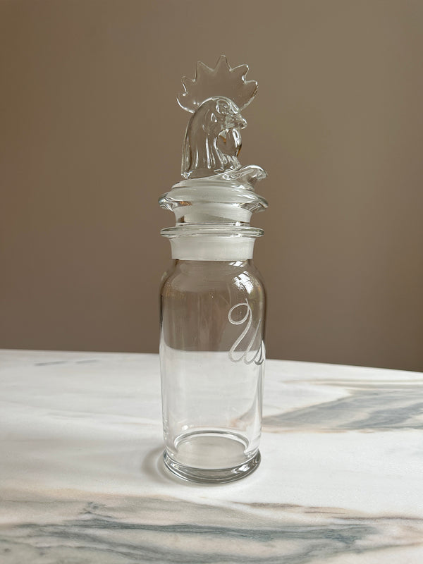 vintage glass dispenser with carved rooster head and 'us' engraving