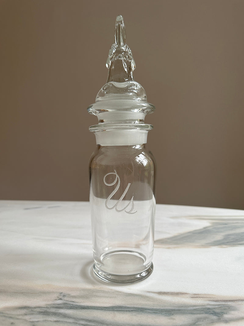vintage glass dispenser with carved rooster head and 'us' engraving