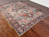 a large antique heriz heritage rug with a faded coral field and a large dark blue medallion
