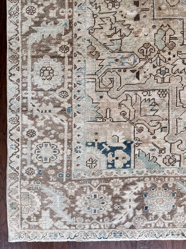 a large vintage heriz rug with a faded neutral palette, blue abrash and taupe accents 