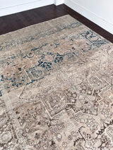 a large vintage heriz rug with a faded neutral palette, blue abrash and taupe accents 