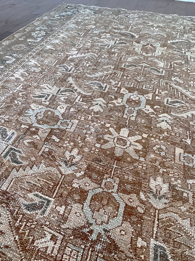 a large vintage heriz rug with brown undertones and teal accents