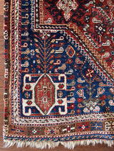 a vintage malayer rug with a dark red field and royal blue corners