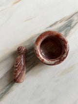 a mini carved marble pestle and mortar