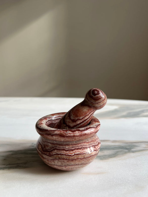 a mini carved marble pestle and mortar