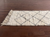 a vintage beni runner with a thick white pile and black diamond pattern