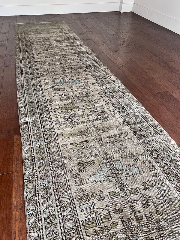 an antique Heriz runner circa 1900 with a neutral grey taupe field and light blue and green accents