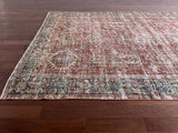 an antique heriz karajah rug with a dark red field and teal blue medallions