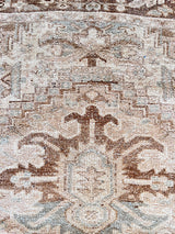 a large vintage heriz rug with a neutral palette and taupe and brown accents