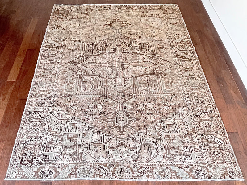 a large vintage heriz rug with a neutral palette and taupe and brown accents