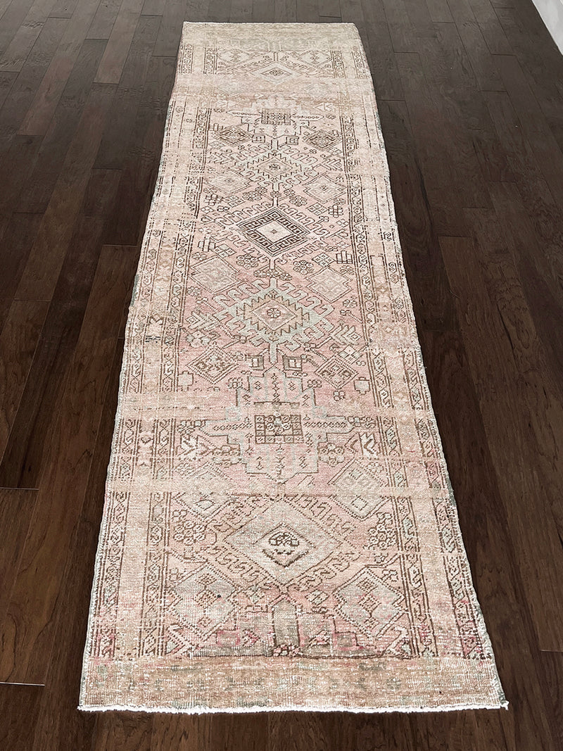a vintage heriz runner with a faded palette and pink and icy blue accents