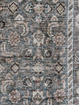 an antique malayer runner with a teal and taupe coloured palette and an intricate cream trellis pattern