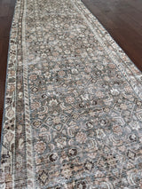 an antique malayer runner with a teal and taupe coloured palette and an intricate cream trellis pattern