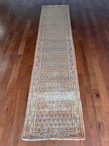 a vintage mir runner with a soft orange field and a fine paisley pattern