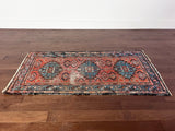 an antique hamadan malayer rug with a coral field and blue medallions
