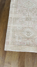 a vintage heriz runner with a faded palette and pink and icy blue accents