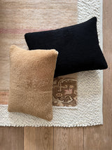 a shearling pillow in camel colored velvet with a plush velvet backing and exposed brass zipper