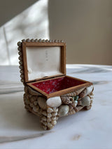 a small vintage box encrusted in pretty little seashells