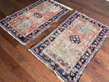 a pair of antique heriz karajah rugs in a faded salmon pink colour with teal and dark blue accents