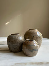 a trio of glazed ceramic jars traditionally used to preserve ginger