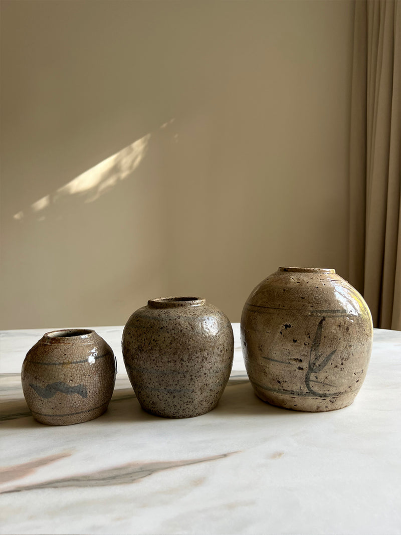 a trio of glazed ceramic jars traditionally used to preserve ginger