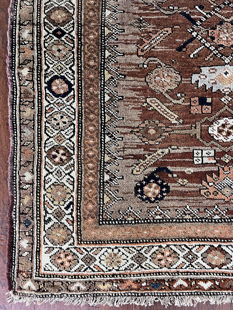 an antique northwest persian runner with a camel, taupe and coral palette and a cream border