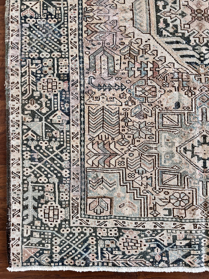 a large heriz runner with a neutral taupe field and dark blue medallions 