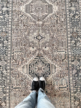 a large heriz runner with a neutral taupe field and dark blue medalli