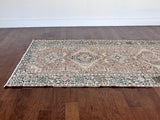 a large heriz runner with a neutral taupe field and dark blue medalli